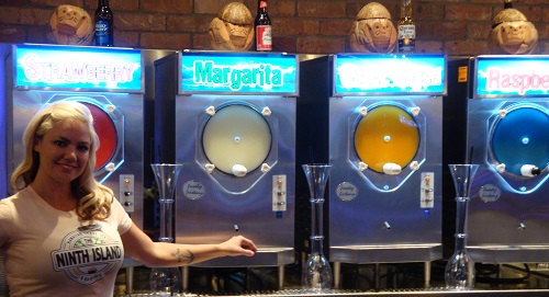  Sexy girl poses with frozen margarita machines at the Night Island Bar inside Downtown Grand