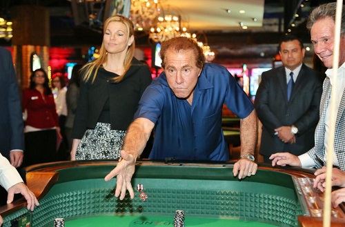 Steve Wynn makes the first roll at the craps table at Downtown Grand