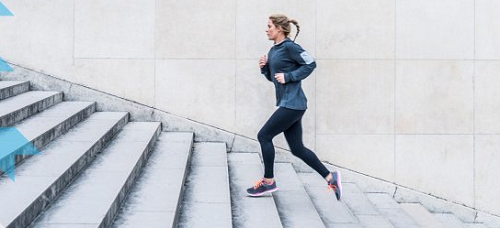 woman jogging up a flight of stairs outside