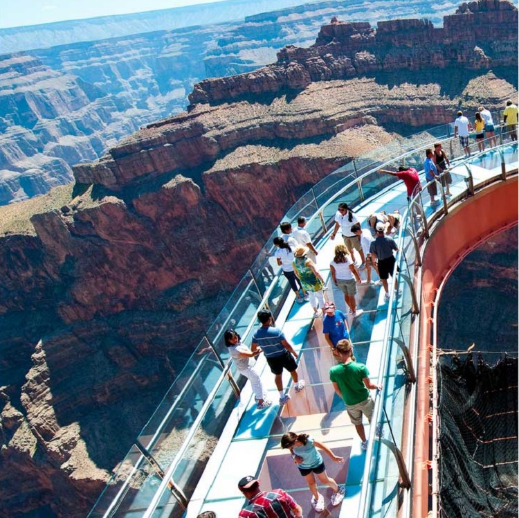 People view the grand canyon on the Skywalk on the Canyon Celebration Sky High Fun Tour